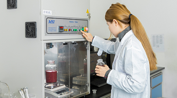 A technician is operating the automatic color matching machine